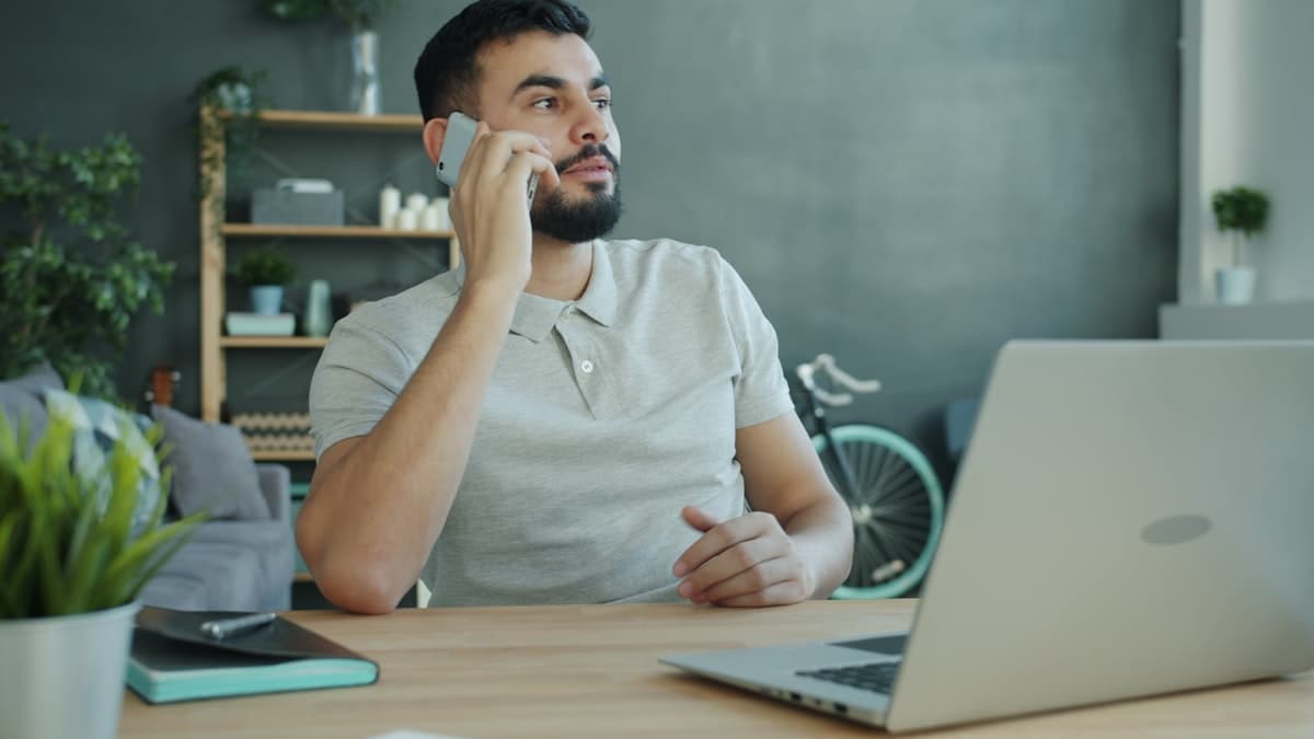 Travel agent on a call at their desk