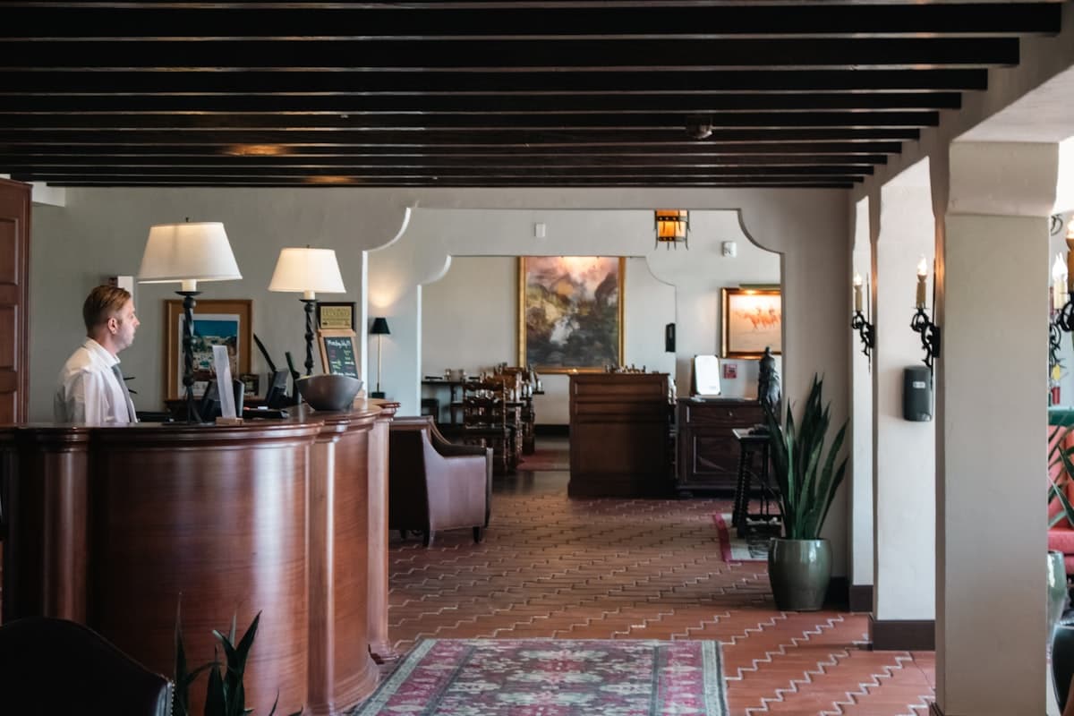 Hotel reception employee welcoming guests